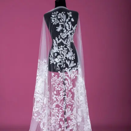 Tulle with off white embroidery.
