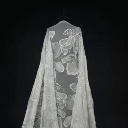 Off White tulle with large, flowy embroidered flowers.